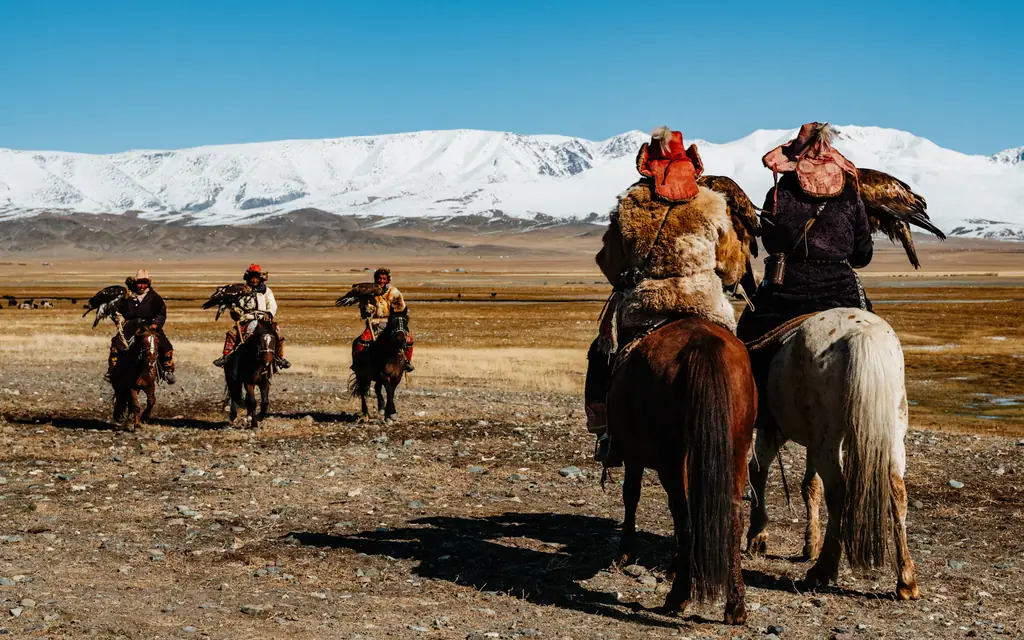 Eagle hunters riding out with their birds