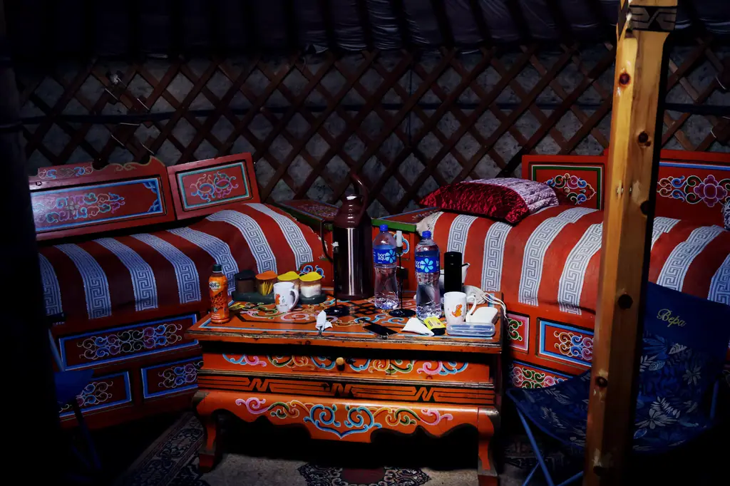 The painted beds and table inside a ger